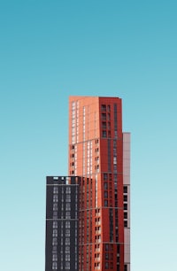 a red and orange building with a blue sky